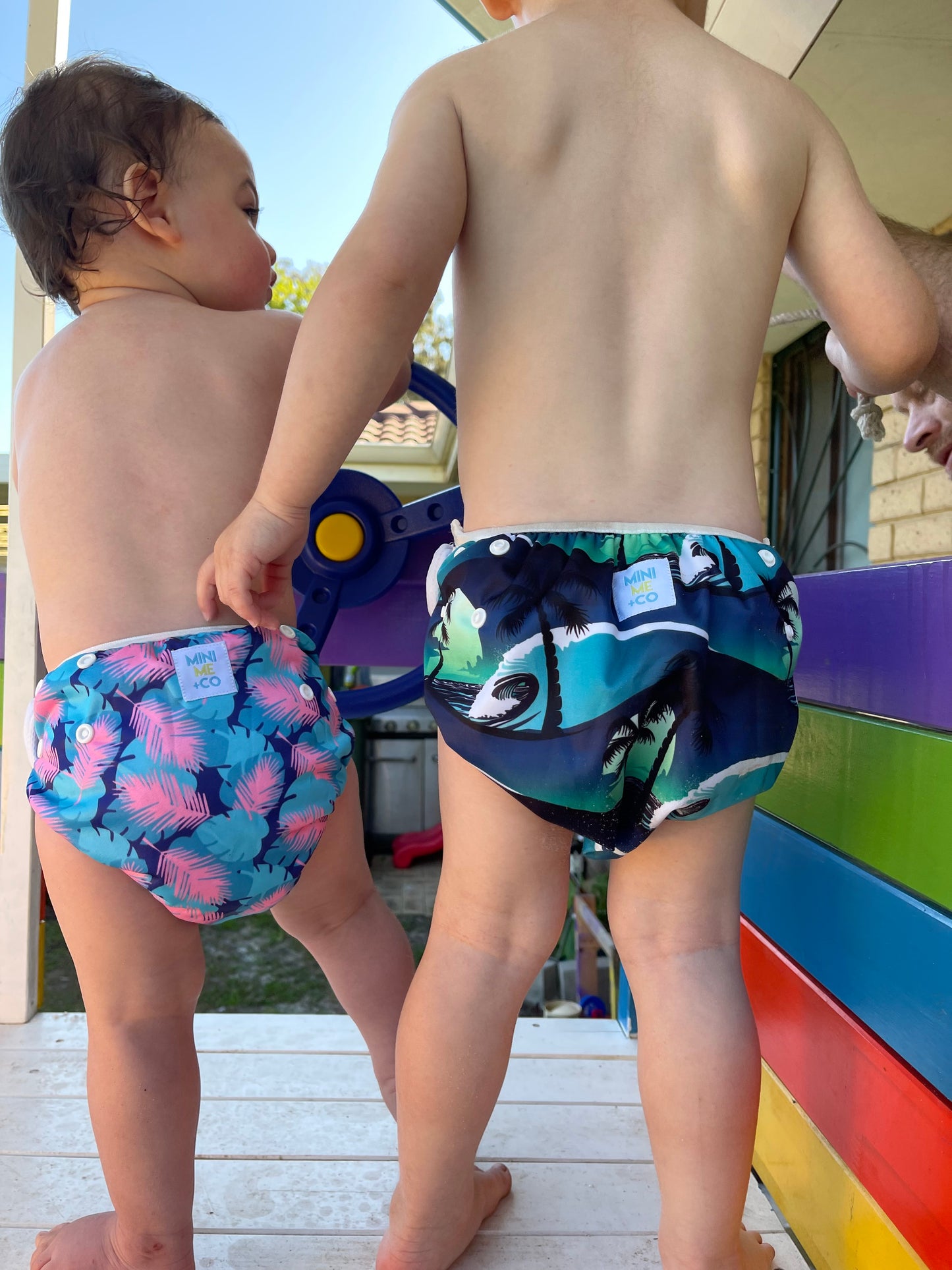 Palm tree-themed swim nappy by Mini Me & Co, crafted for a comfortable fit with leak-proof layers and durable snaps.