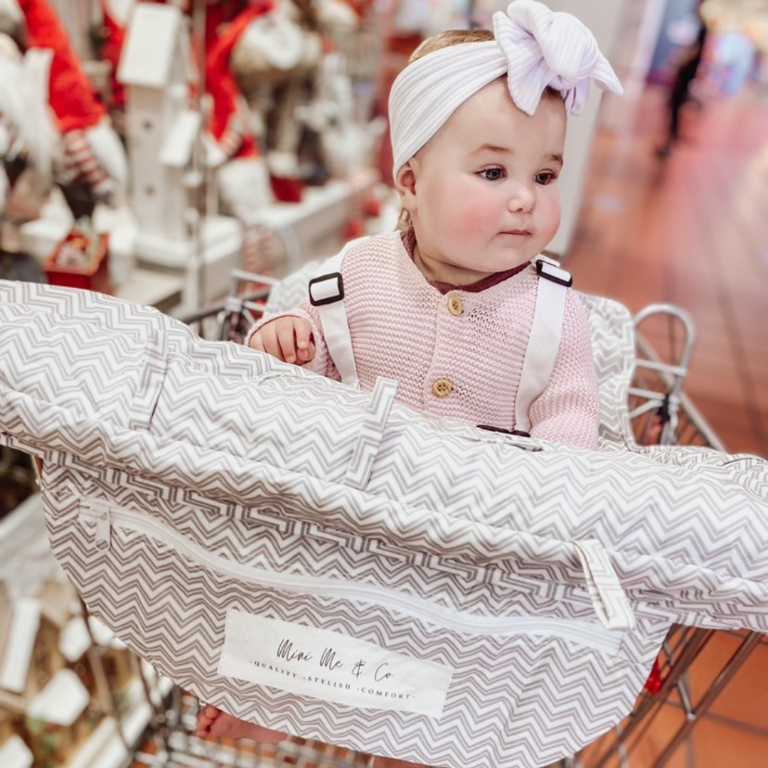 Mini Me & Co Trolley Cover: A vibrant, padded shopping trolley cover designed to protect children from germs while providing comfort and safety during shopping trips.