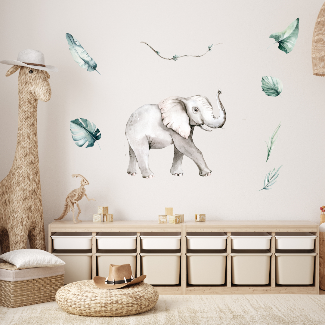 Mini Me & Co elephant wall decal, featuring a charming hand-drawn design that adds a playful touch to kids' rooms and nurseries. This repositionable, non-toxic fabric decal has a matte finish, making it perfect for creating a fun and inviting space."