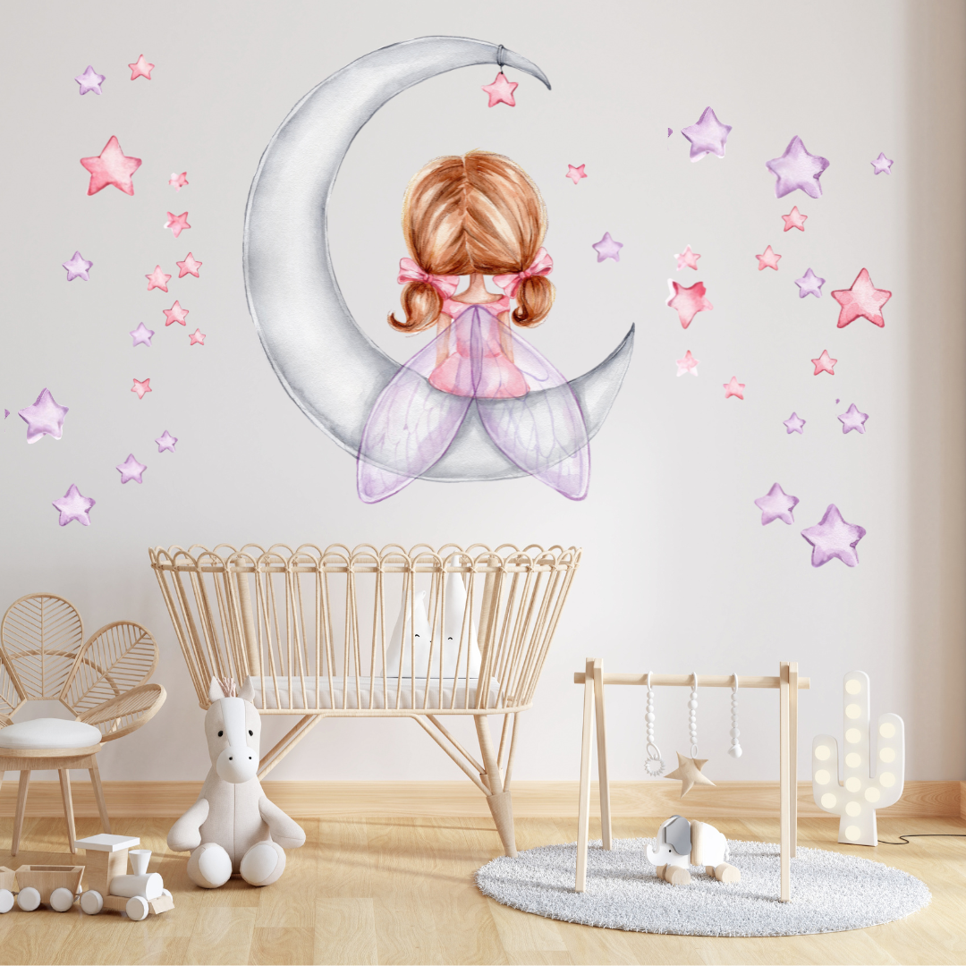 Mini Me & Co fairy on the moon and stars wall decals, featuring enchanting hand-drawn designs that add a whimsical touch to kids' rooms and nurseries. These repositionable, non-toxic fabric decals come with a matte finish, making them perfect for creating a dreamy, celestial atmosphere.