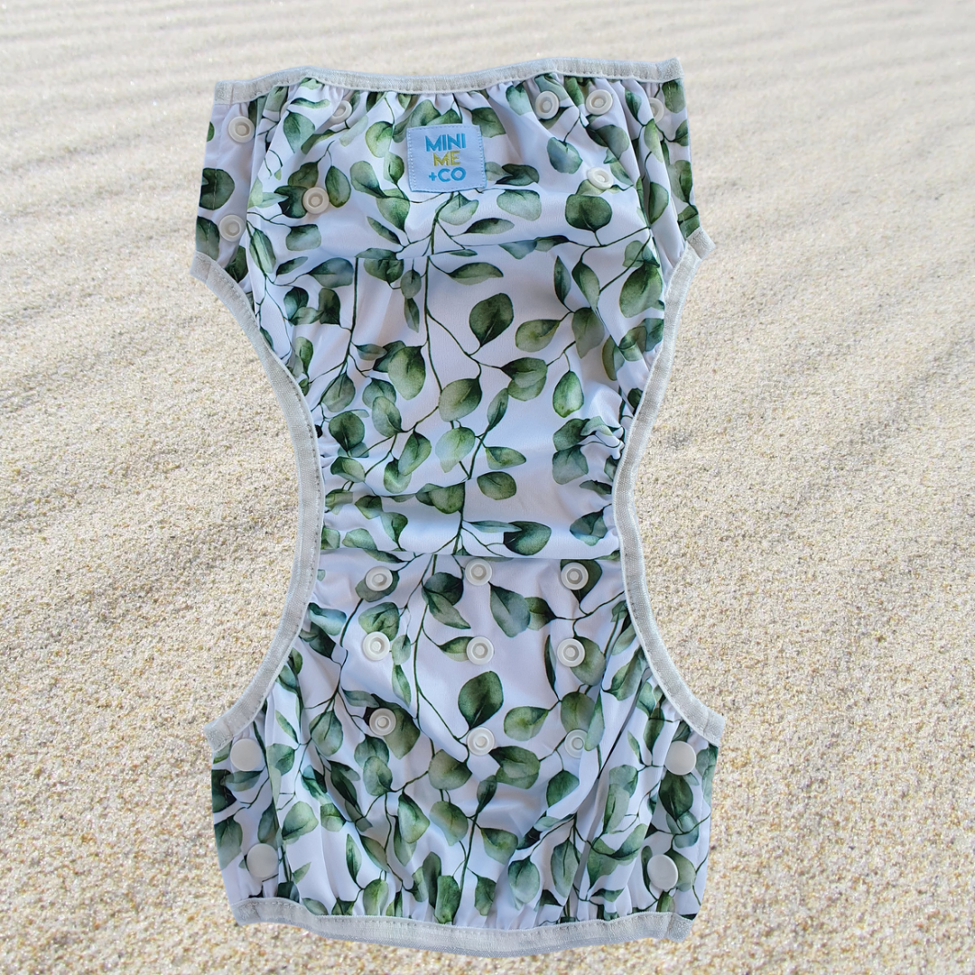 The Eucalyptus Ultimate Swim Package from Mini Me & Co features a reusable swim nappy, waterproof wet bag, and soft hooded towel, all showcasing an elegant eucalyptus design. Made with eco-friendly materials, this package ensures comfort and safety for your child while swimming.