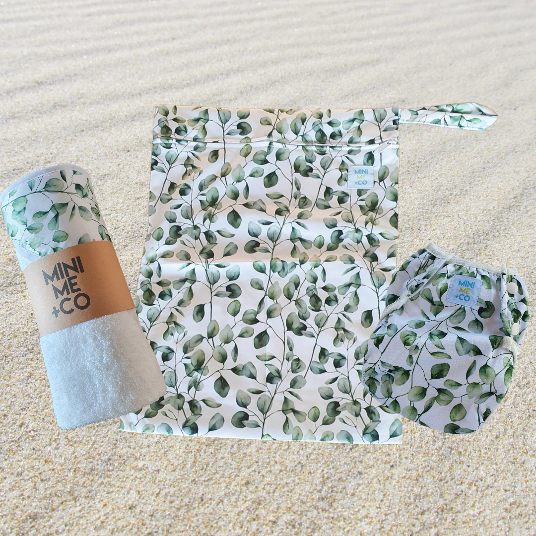 The Mini Me & Co Eucalyptus Ultimate Swim Package includes a reusable swim nappy, a waterproof wet bag, and a soft hooded towel, all featuring a delicate eucalyptus design. Eco-friendly and adjustable, the swim nappy ensures comfort for your little one during beach days and swimming lessons