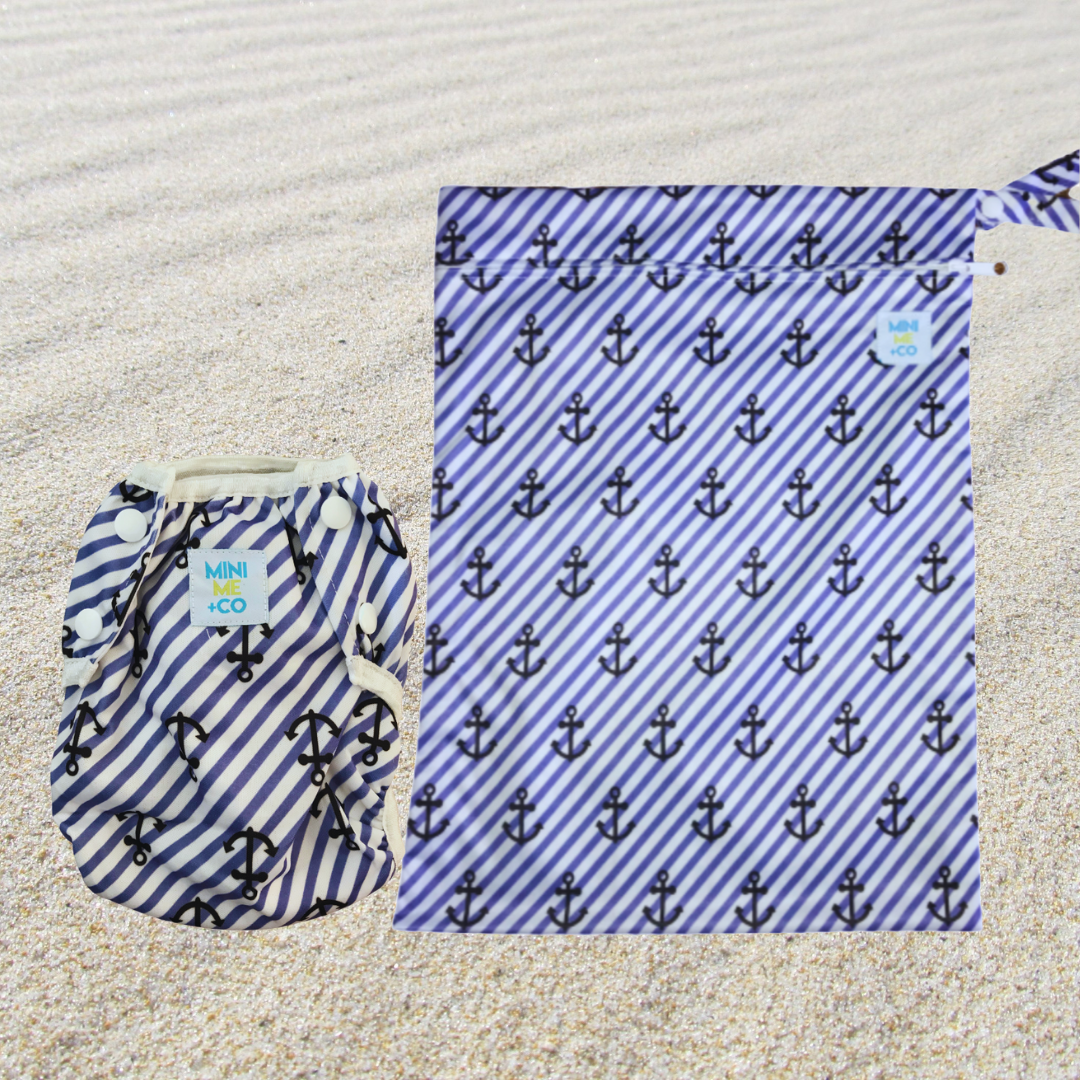 Mini Me & Co anchor set with reusable swim nappy and matching waterproof wet bag, featuring a nautical anchor design, adjustable fit, and leak-proof protection for babies and toddlers.