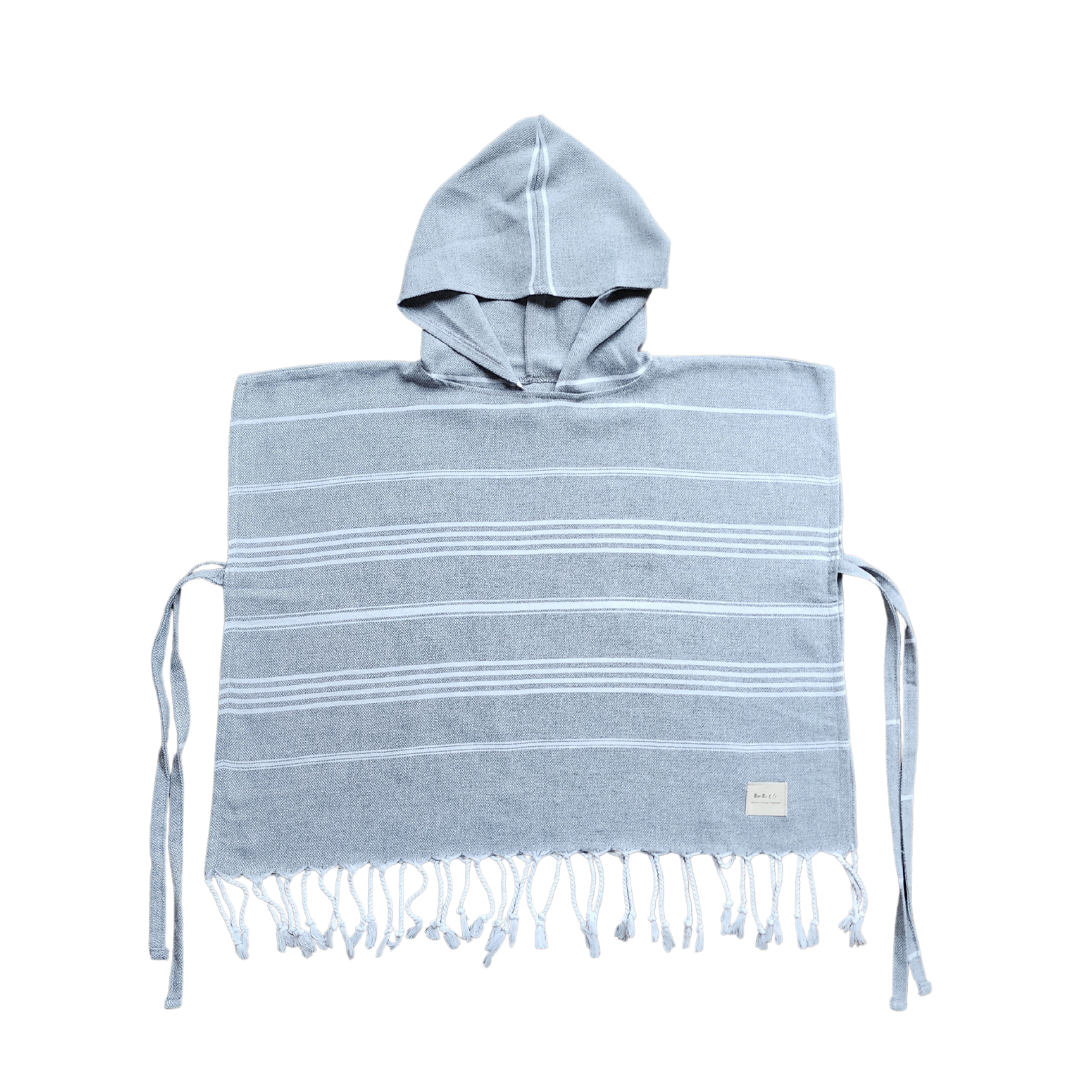 Stylish kids poncho towel, perfect for playtime at the beach or pool, ensuring kids look fashionable while staying dry.