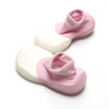 Comfortable pink and white sock shoes for first walkers, offering breathable design and easy fit.