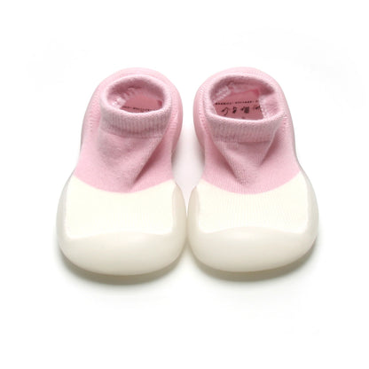 Adorable pink and white two-toned sock shoes for kids with a soft, breathable upper and non-slip rubber sole for secure steps