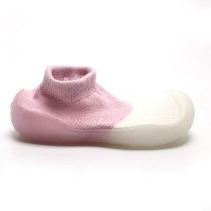 Flexible pink and white sock shoes for kids, promoting natural foot development with every step.