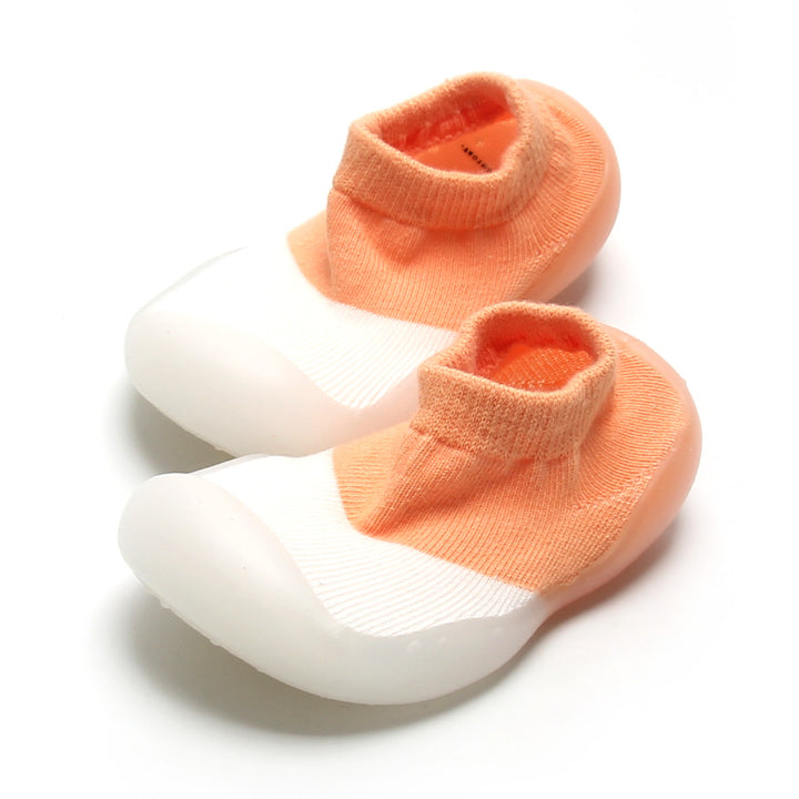 Adorable peach and white sock shoes for active kids with seamless comfort and secure fit.