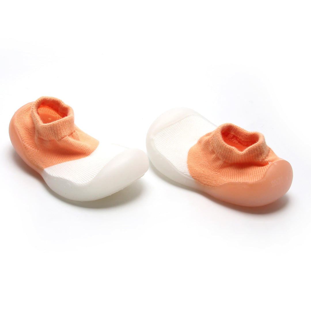 Peach and white sock shoes for toddlers with breathable design and easy slip-on style.