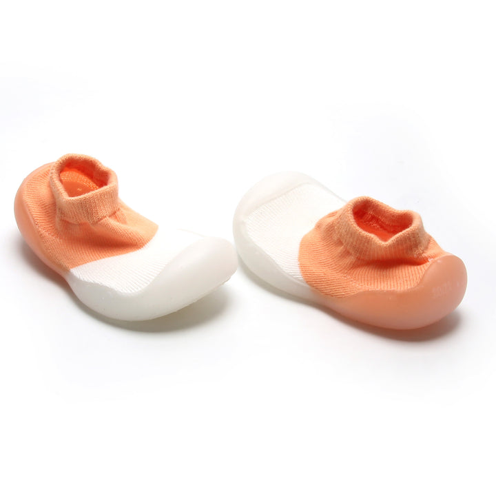 Peach and white sock shoes for toddlers with breathable design and easy slip-on style.