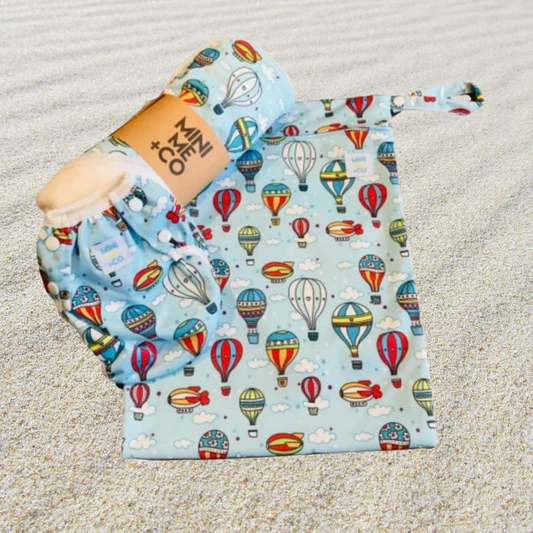 he Hot Air Balloon Swim Package features a delightful collection of swim essentials perfect for adventurous families. This package includes a soft, absorbent swim towel adorned with a whimsical hot air balloon design, ideal for drying off after a swim. Additionally, it comes with a matching waterproof wet bag to securely store wet items and a comfortable reusable swim nappy designed for babies and toddlers. This eco-friendly package combines style and practicality for memorable beach and pool outings.