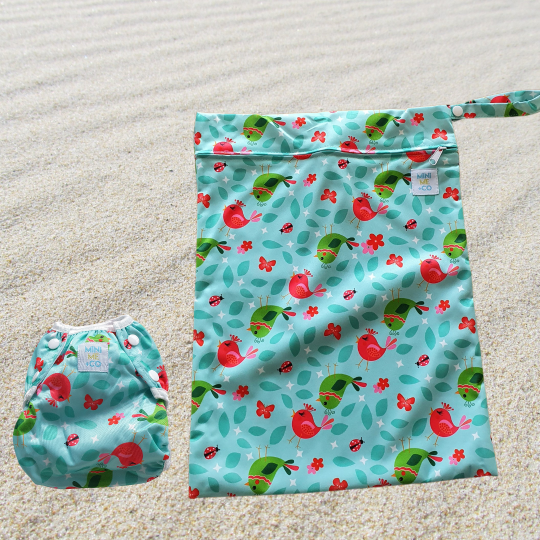 Mini Me & Co Bird Design Reusable Swim Nappy and Waterproof Wet Bag Set, featuring a charming bird pattern, adjustable fit for babies and toddlers, and leak-proof protection for worry-free swim days.