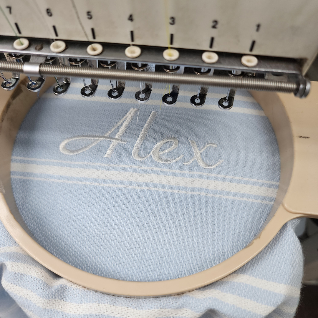 Personalised Kids Poncho Towel: This hooded poncho towel can be customised with your child's name. The elegant script is in white on the soft organic cotton fabric.