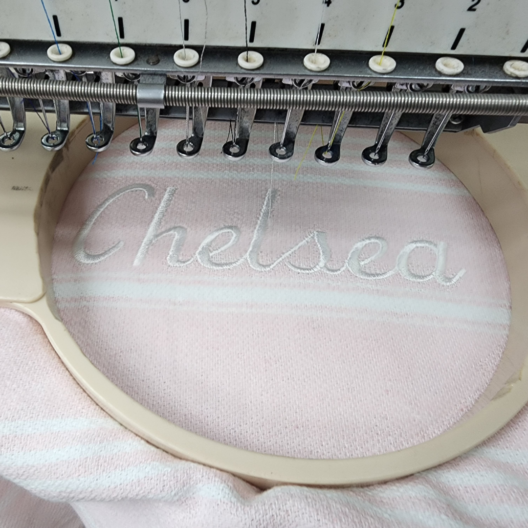 Personalised kids poncho towel featuring a child’s name in elegant script, ideal for making a unique gift.