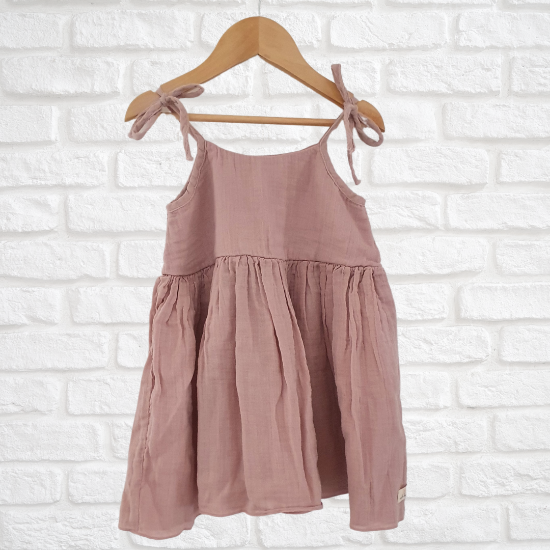 Soft and breathable organic muslin cotton dress with adjustable straps and ruffled hem for kids





