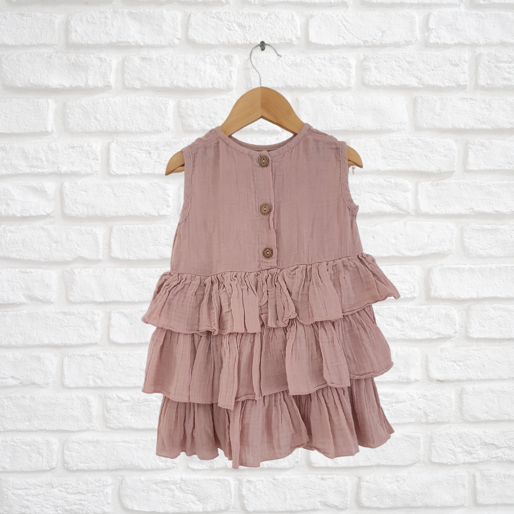 Handmade organic cotton dress with button back and playful ruffled detail for kids
